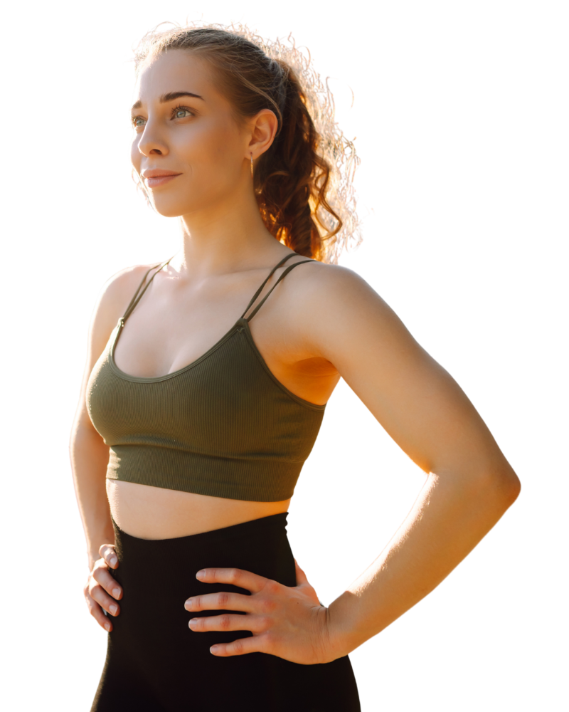 Portrait of a young woman in sportswear, hands on hips