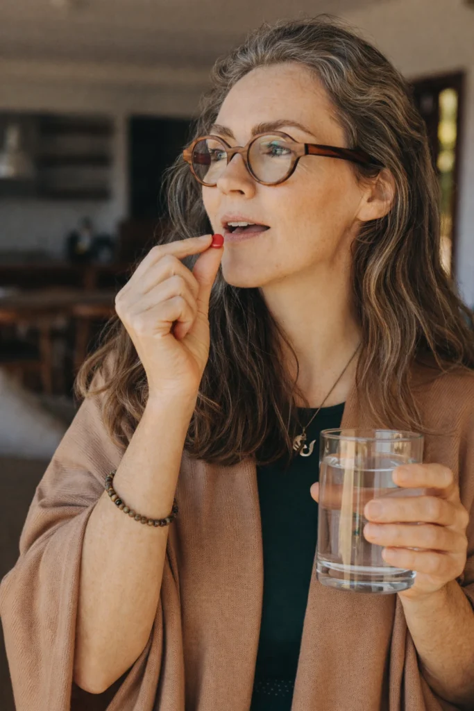 Woman taking Amorex with a glass of water